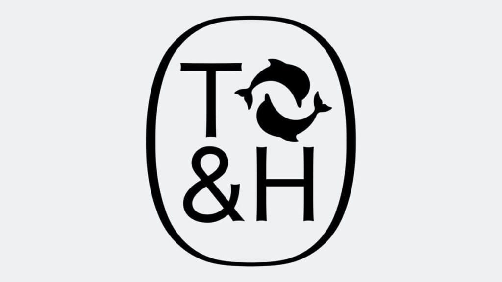 Logo featuring the letters "T" and "H" flanking an ampersand, with two stylized fish circling in the center, all enclosed within an oval shape. The design is minimalist and uses a monochromatic color scheme.