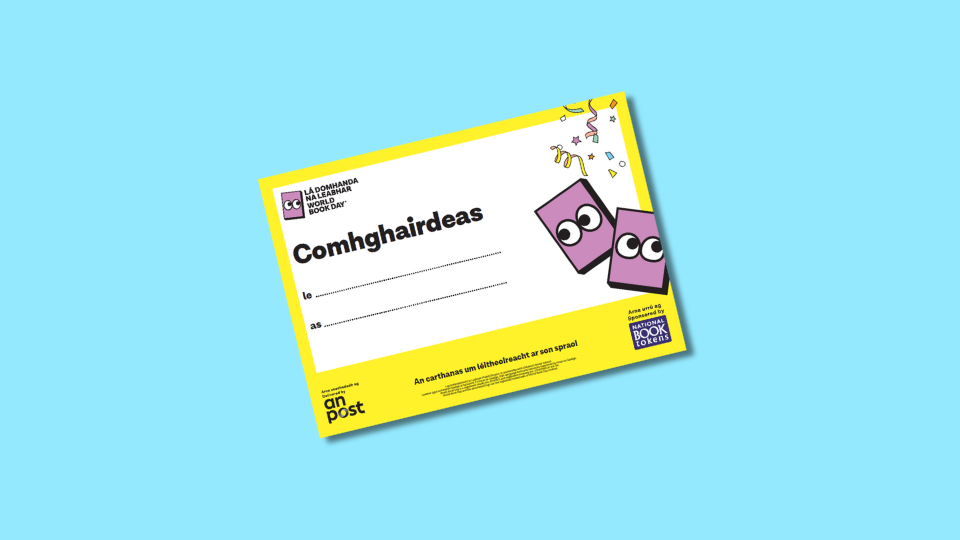 A colourful certificate with a yellow border, featuring cartoon books with eyes, confetti, and the word "Comhghairdeas" in bold text, intended for an Irish language World Book Day celebration.
