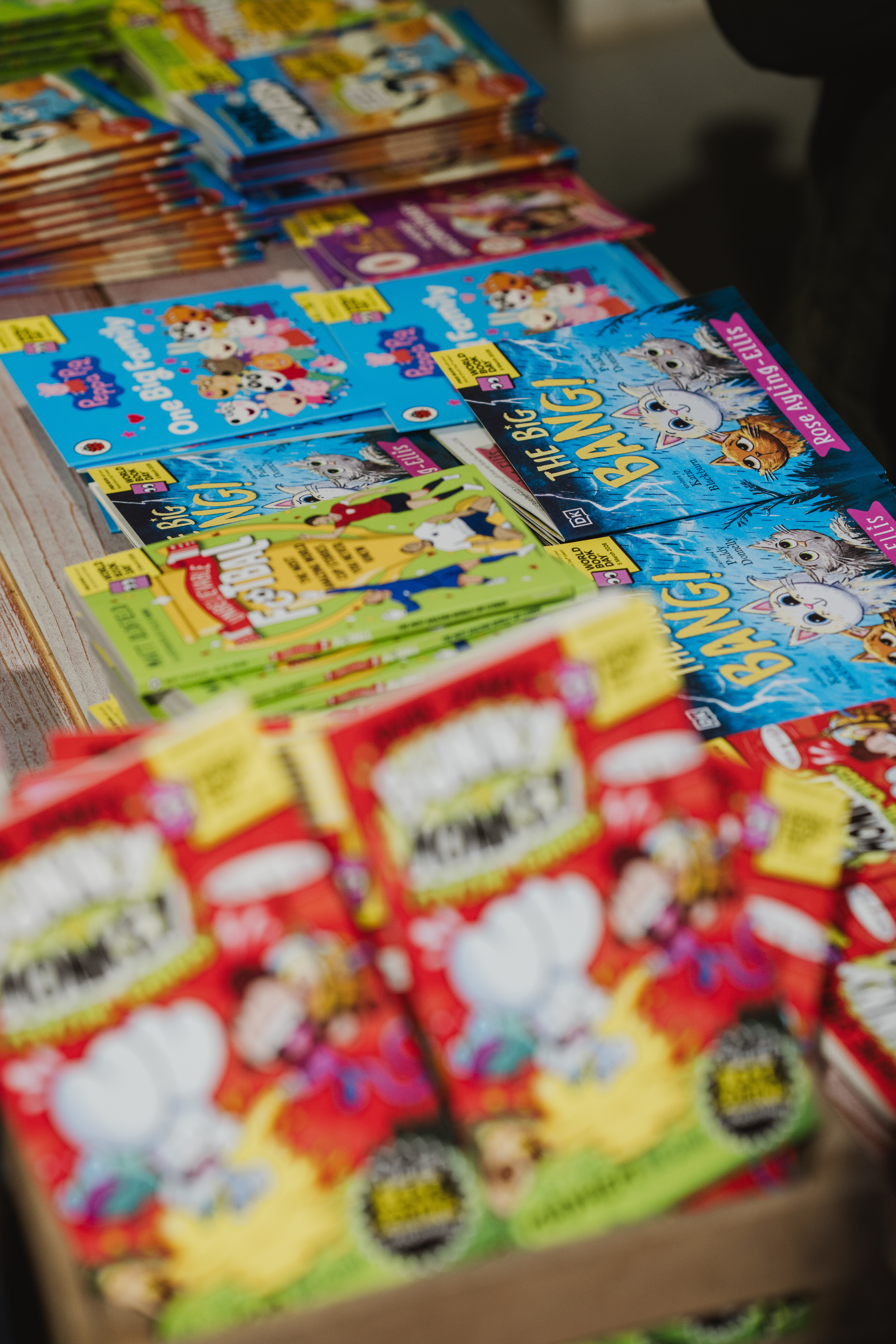 A table filled with colourful children's magazines featuring animated characters and vibrant designs.